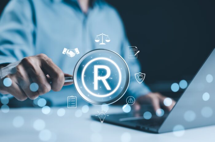 Registered,Trademark,,Intellectual,Property,Concept.,Businessman,Working,On,Laptop,With